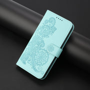 For iPhone 16e Datura Flower Embossed Flip Leather Phone Case(Light Blue)