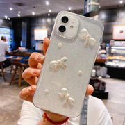 For iPhone 16 Plus Pearl Bow Glitter Epoxy TPU Phone Case(Cross Knots)